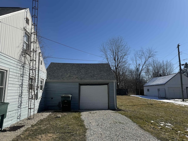 garage with gravel driveway