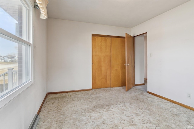 unfurnished bedroom with carpet, baseboards, and a closet