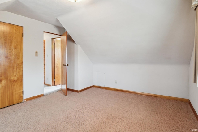 bonus room with vaulted ceiling, carpet floors, and baseboards