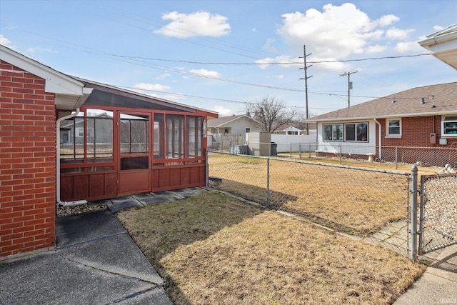 view of yard featuring a sunroom and fence