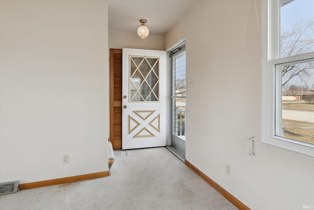 interior space with carpet floors, plenty of natural light, visible vents, and baseboards