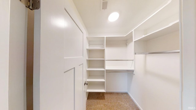 walk in closet with carpet flooring and visible vents