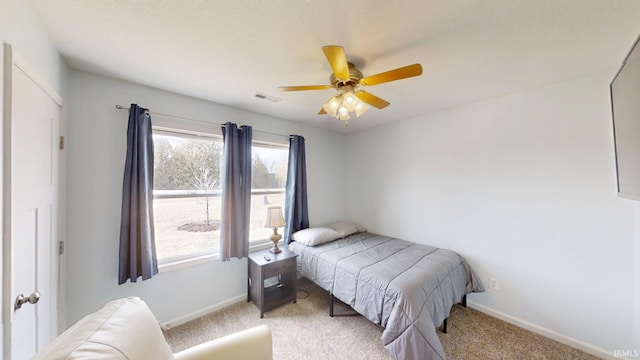 bedroom with visible vents, baseboards, and multiple windows