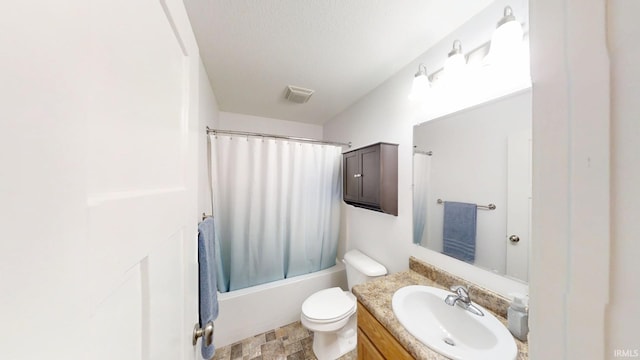 full bath featuring shower / tub combo with curtain, visible vents, toilet, stone finish flooring, and vanity