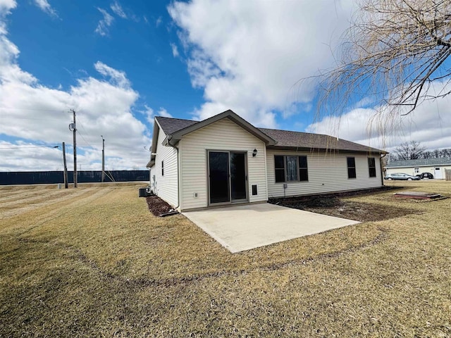 back of property featuring a yard and a patio