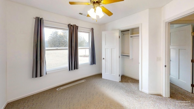 unfurnished bedroom featuring a ceiling fan, visible vents, baseboards, a closet, and carpet