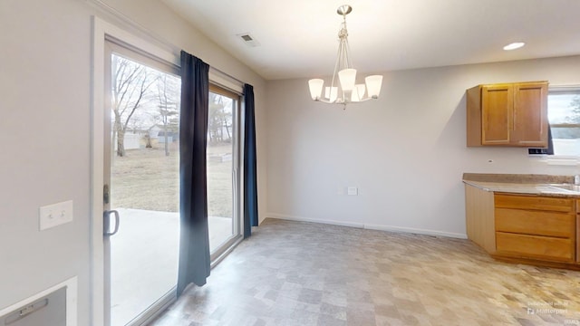 unfurnished dining area with recessed lighting, visible vents, a notable chandelier, and baseboards