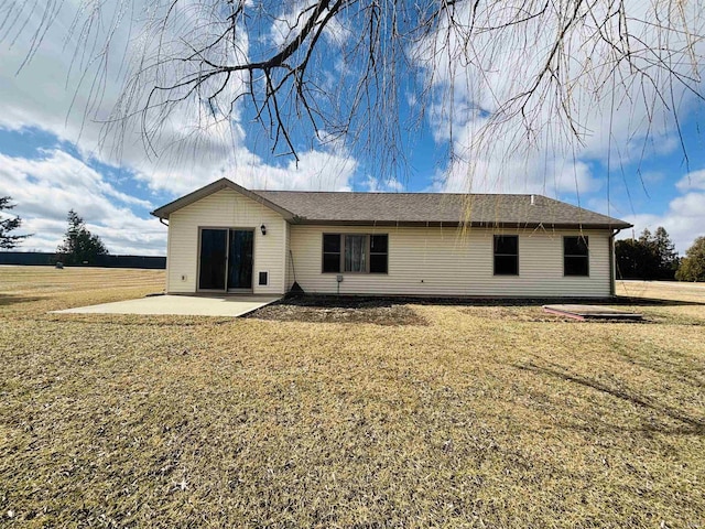 rear view of house with a yard and a patio area