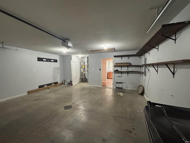 garage featuring water heater, baseboards, and a garage door opener