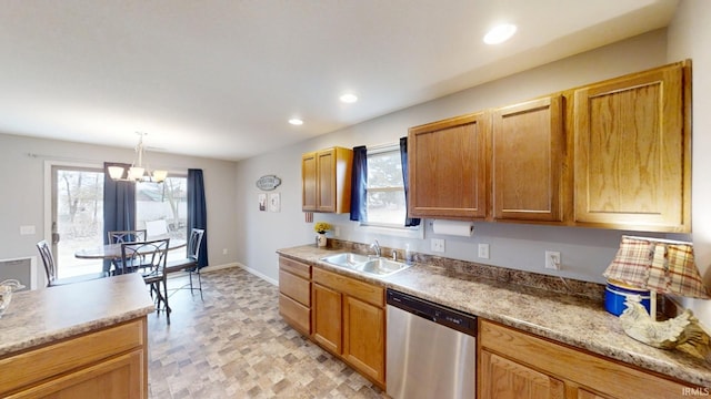 kitchen featuring dishwasher, a sink, a wealth of natural light, and recessed lighting