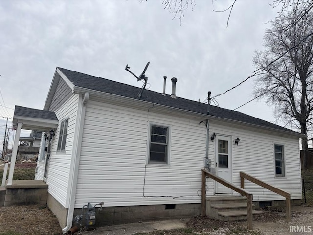 view of property exterior with a shingled roof and crawl space