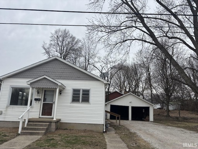 bungalow-style home with an outbuilding and a garage