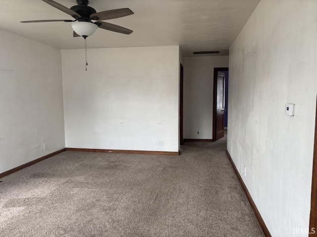 spare room with baseboards, visible vents, ceiling fan, and carpet flooring