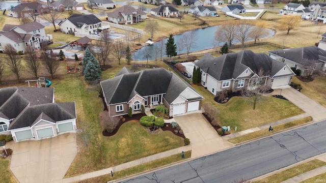 birds eye view of property featuring a water view and a residential view