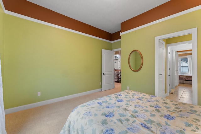 bedroom with light carpet and baseboards