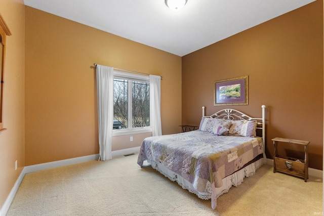 bedroom featuring light carpet, visible vents, and baseboards