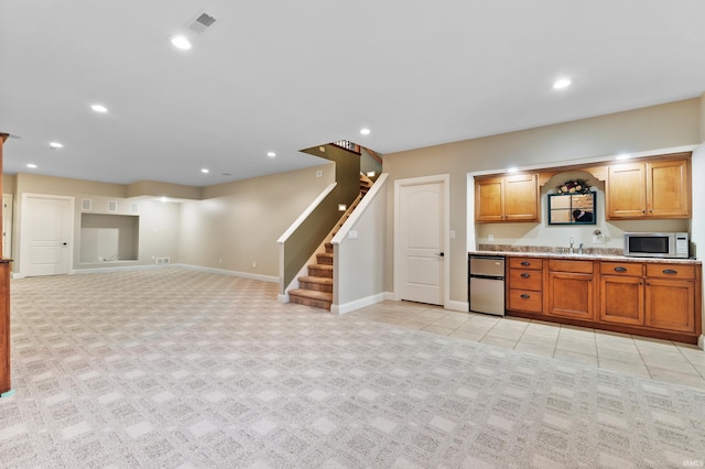 kitchen with recessed lighting, stainless steel microwave, visible vents, and baseboards