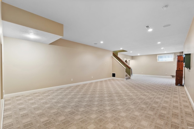 basement featuring recessed lighting, light carpet, visible vents, baseboards, and stairs