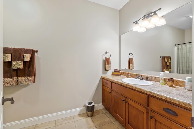 full bathroom featuring vanity, baseboards, and tile patterned floors