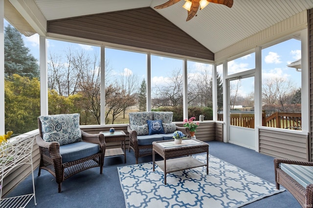 sunroom with a ceiling fan and vaulted ceiling