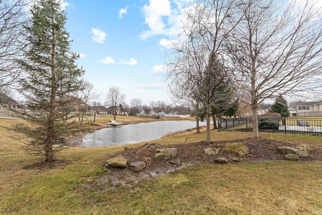 view of yard featuring a water view and fence