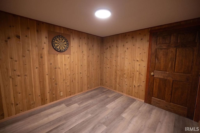 spare room featuring light wood-style floors and baseboards