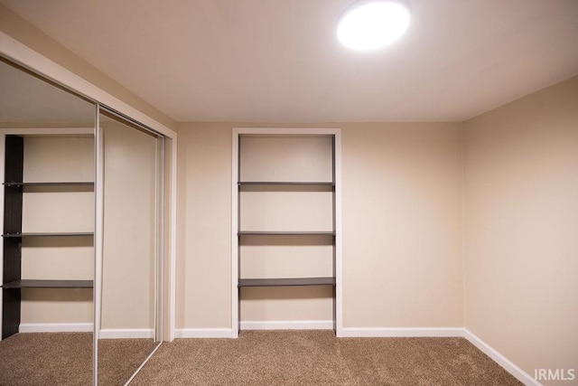 interior space featuring carpet flooring and baseboards