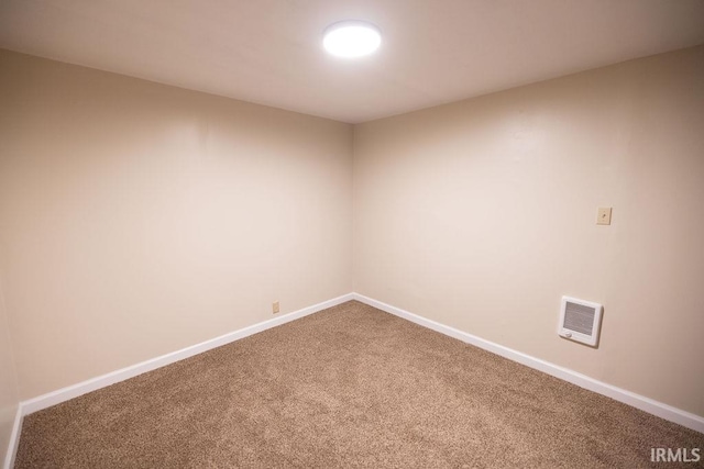 carpeted empty room featuring visible vents and baseboards