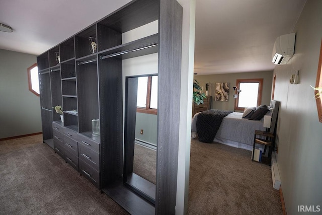 interior space featuring a baseboard heating unit, dark colored carpet, and an AC wall unit