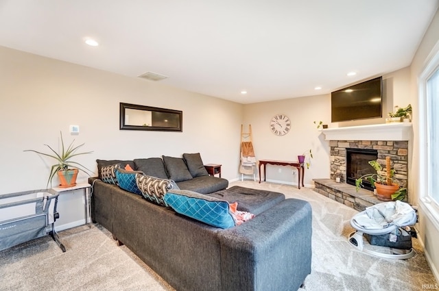 living area with baseboards, a stone fireplace, recessed lighting, and light colored carpet