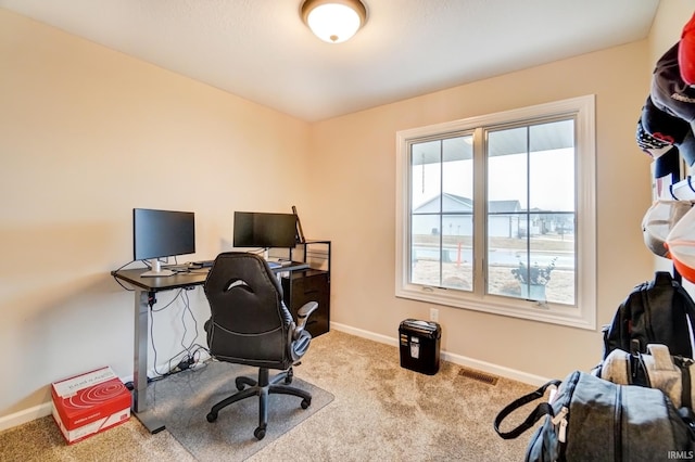 carpeted office space with visible vents and baseboards