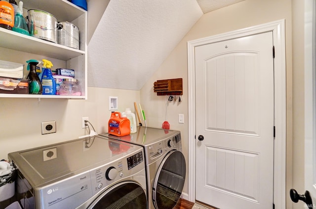 laundry room with a textured ceiling, laundry area, and washing machine and dryer