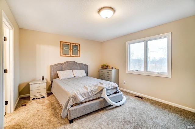 carpeted bedroom featuring visible vents and baseboards