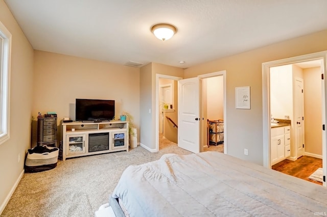 bedroom featuring baseboards, carpet flooring, and ensuite bathroom