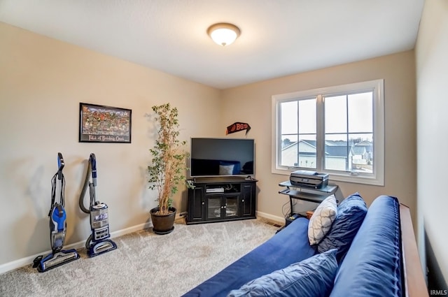 carpeted living area featuring baseboards