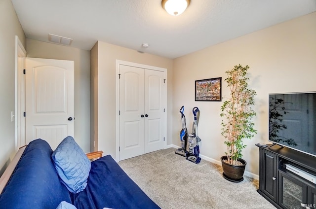 interior space featuring carpet floors, a closet, visible vents, and baseboards