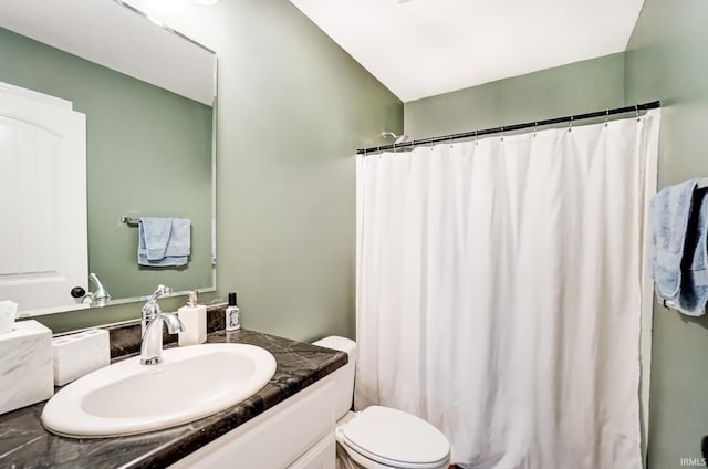 bathroom with toilet, a shower with shower curtain, and vanity