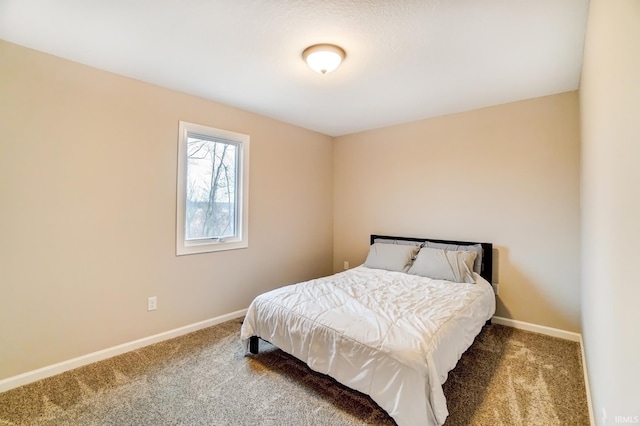 carpeted bedroom featuring baseboards