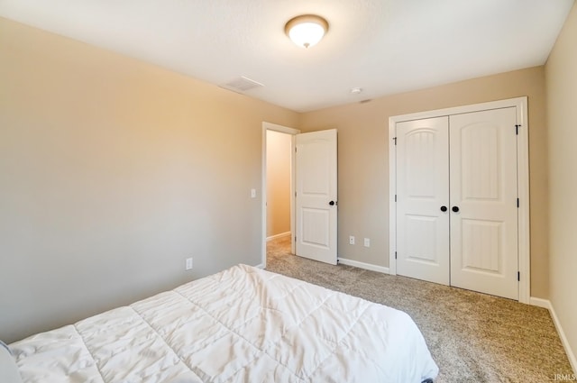 bedroom featuring a closet, carpet flooring, and baseboards