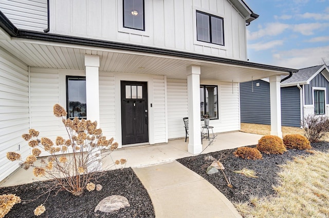 doorway to property with board and batten siding and covered porch