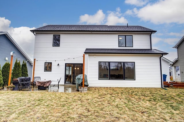 rear view of property featuring roof with shingles, a lawn, an outdoor living space, and a patio