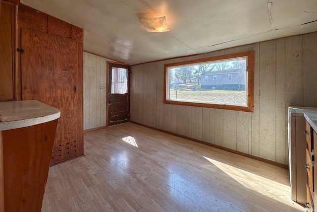 interior space featuring light wood finished floors and baseboards