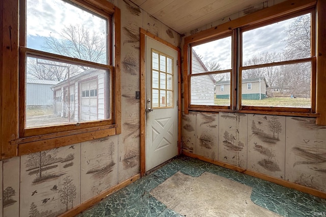 doorway to outside featuring baseboards