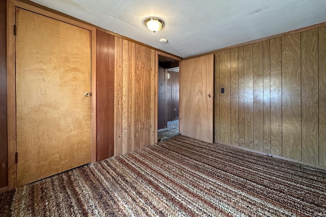 empty room featuring wood walls