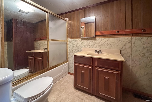 full bathroom with toilet, enclosed tub / shower combo, visible vents, and vanity