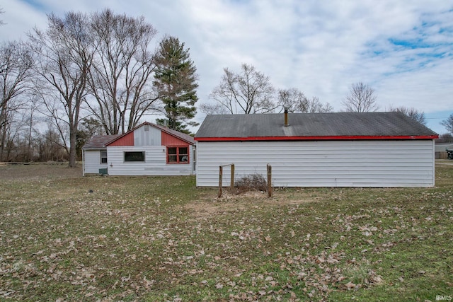 back of property with a lawn