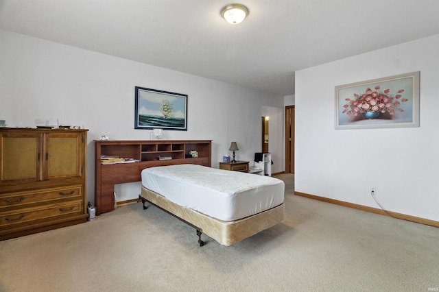 bedroom featuring baseboards and light colored carpet