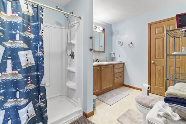 full bath with backsplash, toilet, a shower stall, vanity, and baseboards