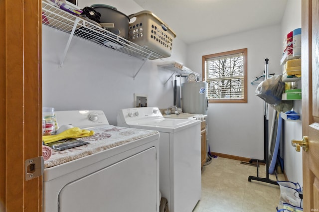 washroom featuring laundry area, washing machine and dryer, and baseboards