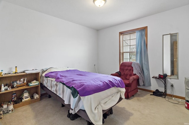 carpeted bedroom featuring baseboards